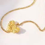 Load image into Gallery viewer, Adanna unique gold necklace lying on neutral background with shadow