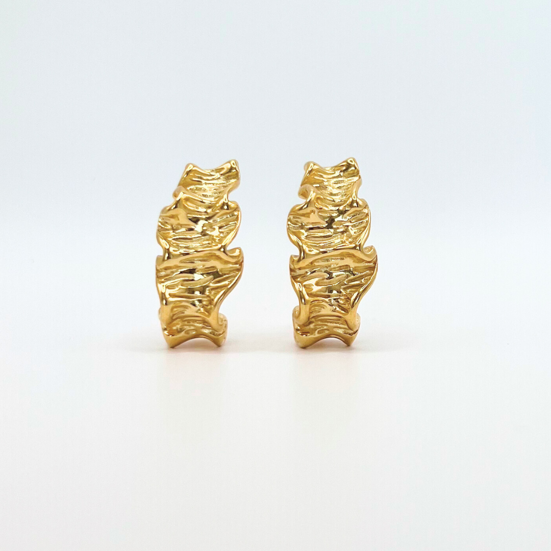 adanna unusual gold earrings, with shadow and neutral white background